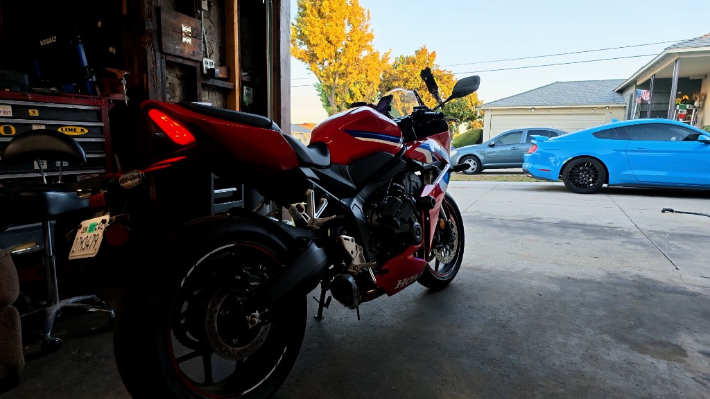 Red Honda CBR650R in the garage — rear three-quarter view